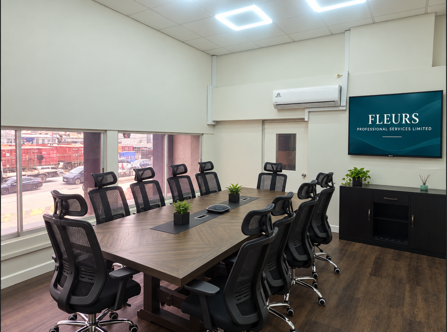 Executive meeting room with 12 chairs and a wall-mounted Fleurs company monitor
